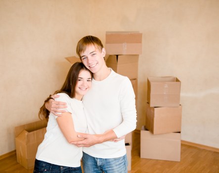 Professional movers handling goods in removal truck